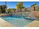 Backyard pool featuring a unique tiled waterfall accent wall, providing a soothing ambiance at 2111 Bogart Ct, Las Vegas, NV 89117