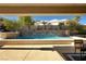 Backyard pool with a rock waterfall feature and desert landscaping at 2111 Bogart Ct, Las Vegas, NV 89117