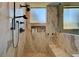 Enjoy this spa like shower with marble surround, dual shower heads, and a built in bench at 2111 Bogart Ct, Las Vegas, NV 89117
