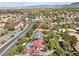 Aerial view showing a house with a pool and surrounding houses at 2225 Versailles Ct, Henderson, NV 89074