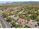 An aerial view of a house with a pool and a large backyard, surrounded by other houses at 2225 Versailles Ct, Henderson, NV 89074