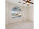 Bedroom with arched window, ceiling fan, and neutral decor at 3455 Halter Dr, Las Vegas, NV 89122