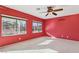 Bright bedroom with red walls and large windows at 3455 Halter Dr, Las Vegas, NV 89122