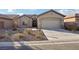 House exterior showcasing a two-car garage and landscaping at 3455 Halter Dr, Las Vegas, NV 89122