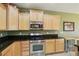 Kitchen boasts stainless steel appliances and dark granite countertops at 3455 Halter Dr, Las Vegas, NV 89122