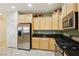 Modern kitchen featuring stainless steel appliances and light wood cabinets at 3455 Halter Dr, Las Vegas, NV 89122