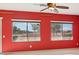 Bright living room with red walls and large windows at 3455 Halter Dr, Las Vegas, NV 89122