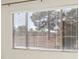 View from window shows backyard with trees and fence at 3455 Halter Dr, Las Vegas, NV 89122