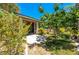 Secluded backyard featuring a covered patio and lush greenery, perfect for outdoor relaxation and entertaining at 3709 Citrus Heights Ave, North Las Vegas, NV 89081