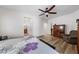 Spacious bedroom with wood look floors, ceiling fan, and a glimpse into the bathroom at 3709 Citrus Heights Ave, North Las Vegas, NV 89081