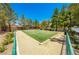 Well-maintained bocce ball court featuring artificial turf, bordered by trees and landscaping, perfect for outdoor recreation at 3709 Citrus Heights Ave, North Las Vegas, NV 89081