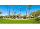 Clubhouse entrance with manicured lawn, palm trees, and inviting signage, offering a welcoming community space at 3709 Citrus Heights Ave, North Las Vegas, NV 89081