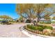 Beautiful clubhouse exterior with landscaped entrance, mature trees, and a circular driveway, creating an inviting atmosphere at 3709 Citrus Heights Ave, North Las Vegas, NV 89081
