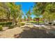 Scenic community park with lush greenery, mature trees, a walking path and informational sign, providing a peaceful outdoor space at 3709 Citrus Heights Ave, North Las Vegas, NV 89081