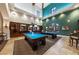 Bright game room with two billiard tables and a decorative bar area for entertaining at 3709 Citrus Heights Ave, North Las Vegas, NV 89081