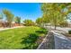 Expansive green space with a paved walking path, surrounded by trees and landscaping, great for recreation and relaxation at 3709 Citrus Heights Ave, North Las Vegas, NV 89081