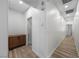Bright hallway featuring wood-look flooring, a wooden storage cabinet, and neutral walls at 3709 Citrus Heights Ave, North Las Vegas, NV 89081