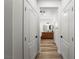 Hallway with access to bathroom featuring double sinks and wood-look tile floors at 3709 Citrus Heights Ave, North Las Vegas, NV 89081