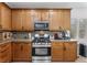 Kitchen features wood cabinets, granite countertops, and stainless steel appliances providing ample space for cooking at 3709 Citrus Heights Ave, North Las Vegas, NV 89081