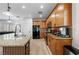 Features of the kitchen include wood cabinets, granite countertops, a black refrigerator, and wood-look floors at 3709 Citrus Heights Ave, North Las Vegas, NV 89081