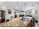 Spacious kitchen island with granite countertops, double sink, and stainless steel dishwasher in a home with an open layout at 3709 Citrus Heights Ave, North Las Vegas, NV 89081