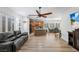 Open-concept living room featuring wood-look flooring and a ceiling fan, flowing into the kitchen area at 3709 Citrus Heights Ave, North Las Vegas, NV 89081