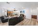Spacious living room with sleek wood-look flooring that connects to the open-concept kitchen at 3709 Citrus Heights Ave, North Las Vegas, NV 89081
