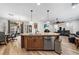 Spacious living space featuring a kitchen island, dining area, living room, and plenty of natural light at 3709 Citrus Heights Ave, North Las Vegas, NV 89081