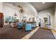 Inviting lounge area with cozy seating, fireplace, and multiple chandeliers at 3709 Citrus Heights Ave, North Las Vegas, NV 89081