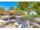 Park pavilion with picnic tables and shade, set in a grassy area with mature trees, ideal for outdoor gatherings at 3709 Citrus Heights Ave, North Las Vegas, NV 89081