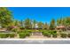 Formal entrance to Rose Park with manicured hedges and landscaping, featuring covered seating areas and a welcoming sign at 3709 Citrus Heights Ave, North Las Vegas, NV 89081