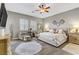 Bedroom features neutral paint, hardwood floors, sitting area and a ceiling fan at 480 Heritage Bridge Ave, Henderson, NV 89011