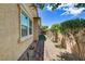 Exterior featuring a well-maintained yard with lush greenery, stone pathway, and neutral toned stucco home at 480 Heritage Bridge Ave, Henderson, NV 89011