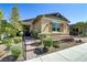 Charming single-story home with a covered entry, manicured landscaping, and a stone-lined garden at 480 Heritage Bridge Ave, Henderson, NV 89011