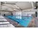 Inviting indoor pool with natural light, accessible stairs, and tiled deck, ideal for recreation and exercise at 480 Heritage Bridge Ave, Henderson, NV 89011