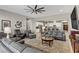 Open floor plan of living room featuring neutral paint, stylish furniture and kitchen views at 480 Heritage Bridge Ave, Henderson, NV 89011