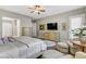 This main bedroom features neutral walls, a ceiling fan, a TV, and an ensuite bathroom at 480 Heritage Bridge Ave, Henderson, NV 89011
