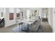 Modern dining room with a marble table and gray chairs near sliding doors at 6521 Macdoogle St, Las Vegas, NV 89166