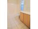 Bathroom with tub, toilet and wood cabinets at 6740 Silent Vista Way, Las Vegas, NV 89122