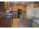 Modern kitchen with granite countertops and wood cabinets at 6740 Silent Vista Way, Las Vegas, NV 89122