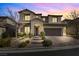 Two-story house with a landscaped yard and brick pathway at 12730 Coastline Shadow St, Las Vegas, NV 89141