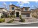 Two story house with gray garage door and landscaping at 12730 Coastline Shadow St, Las Vegas, NV 89141