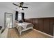 Comfortable bedroom with a ceiling fan, stylish accent wall, and natural light at 155 E Van Wagenen St, Henderson, NV 89015