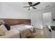 Bright bedroom with a paneled accent wall, ceiling fan, and ample closet space at 155 E Van Wagenen St, Henderson, NV 89015