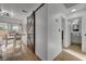 Hallway with rustic sliding barn door, conveniently located near the kitchen and bathroom at 155 E Van Wagenen St, Henderson, NV 89015