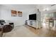 Open-concept living room with a entertainment center, comfortable seating, and natural wood flooring at 155 E Van Wagenen St, Henderson, NV 89015