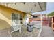 Outdoor patio with seating, ideal for relaxation or entertaining with a white Adirondack chair at 155 E Van Wagenen St, Henderson, NV 89015