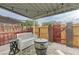 Inviting covered patio with bench seating, barrel table, and ambient string lights at 155 E Van Wagenen St, Henderson, NV 89015