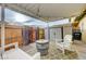 Cozy covered patio with white furniture, barrel table, and convenient outdoor storage shed at 155 E Van Wagenen St, Henderson, NV 89015