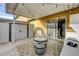 Relaxing covered patio featuring a barrel table, Adirondack chairs, and easy access to the house at 155 E Van Wagenen St, Henderson, NV 89015